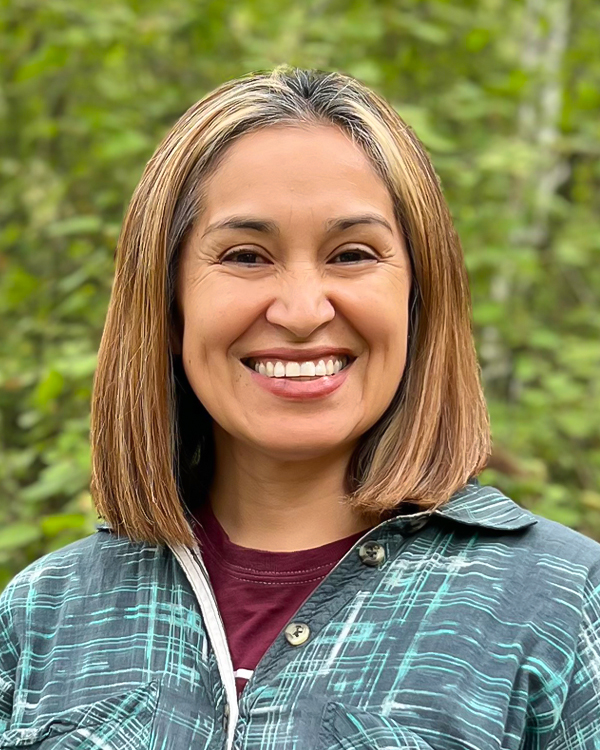 a woman, Carmen Orozco, smiling