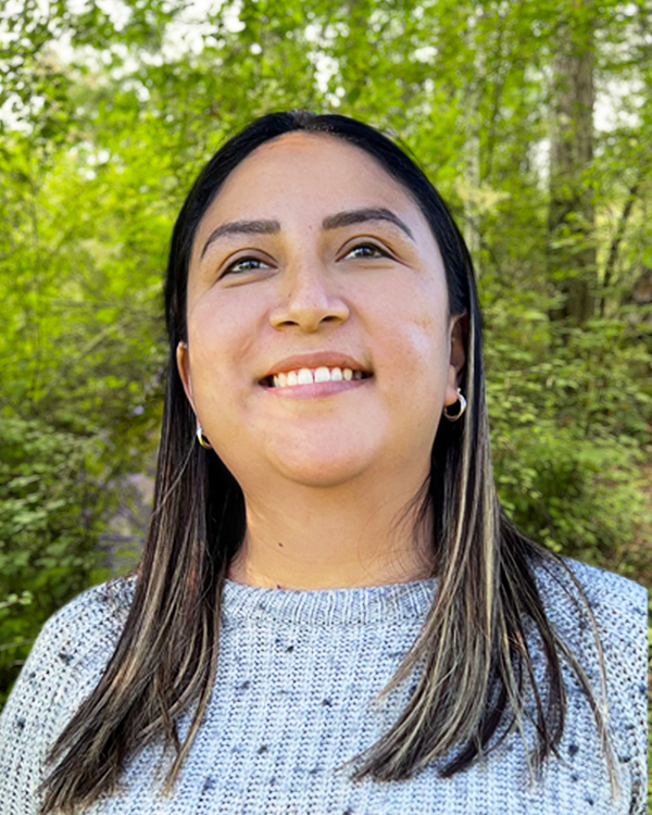 a woman, Adriana Gonzalez, smiling