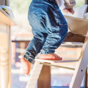 young child is barefoot on stepping stool