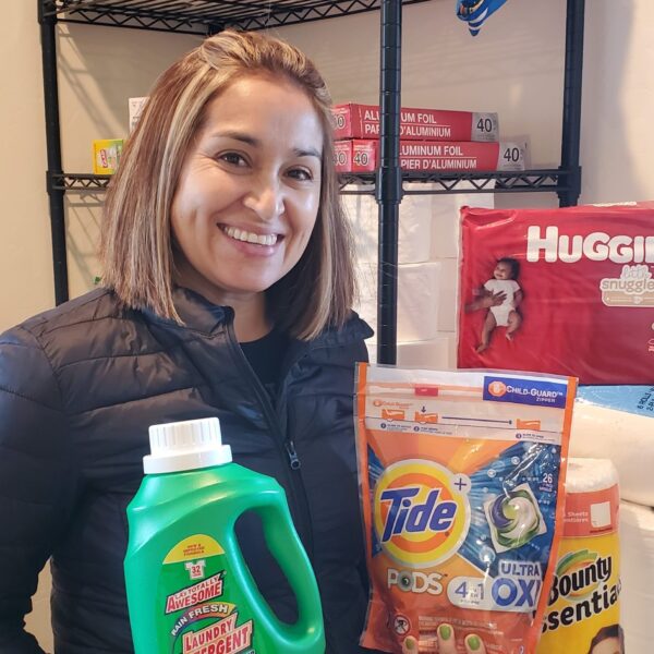 woman smiling holding laundry detergent