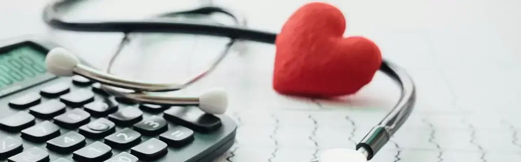 health insurance header with heart stethoscope and calculator