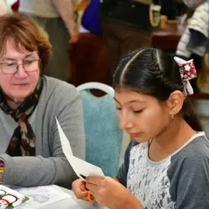 mentoring student cutting crafting paper