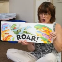 Reading dinosaur book at the library